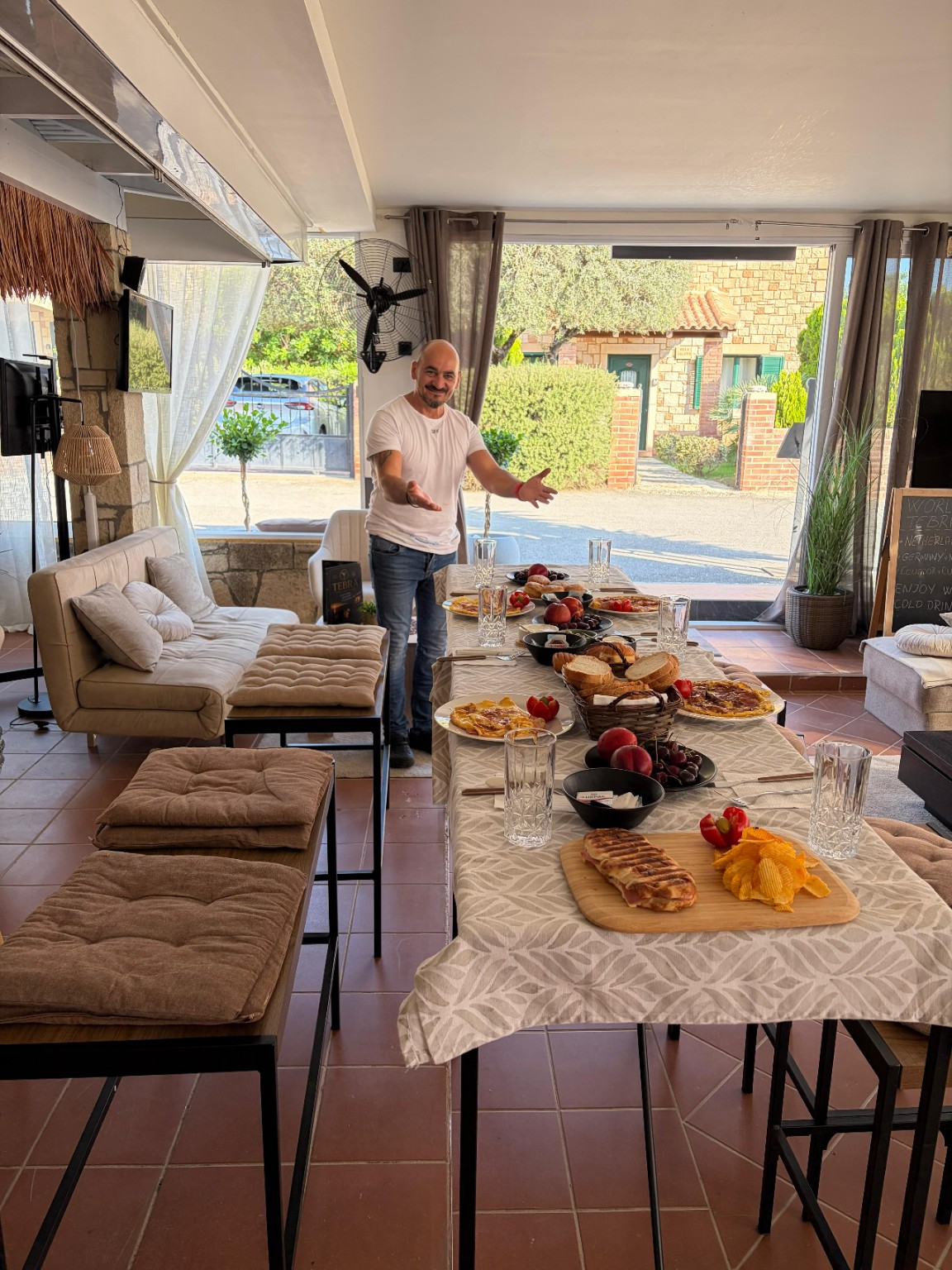 Zac welcoming guests to a breakfast table at Tebra
